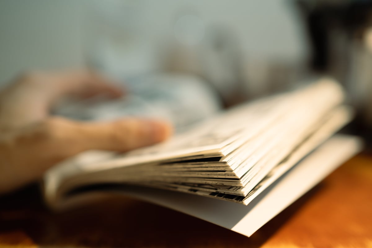 A reader flipping through a comic book