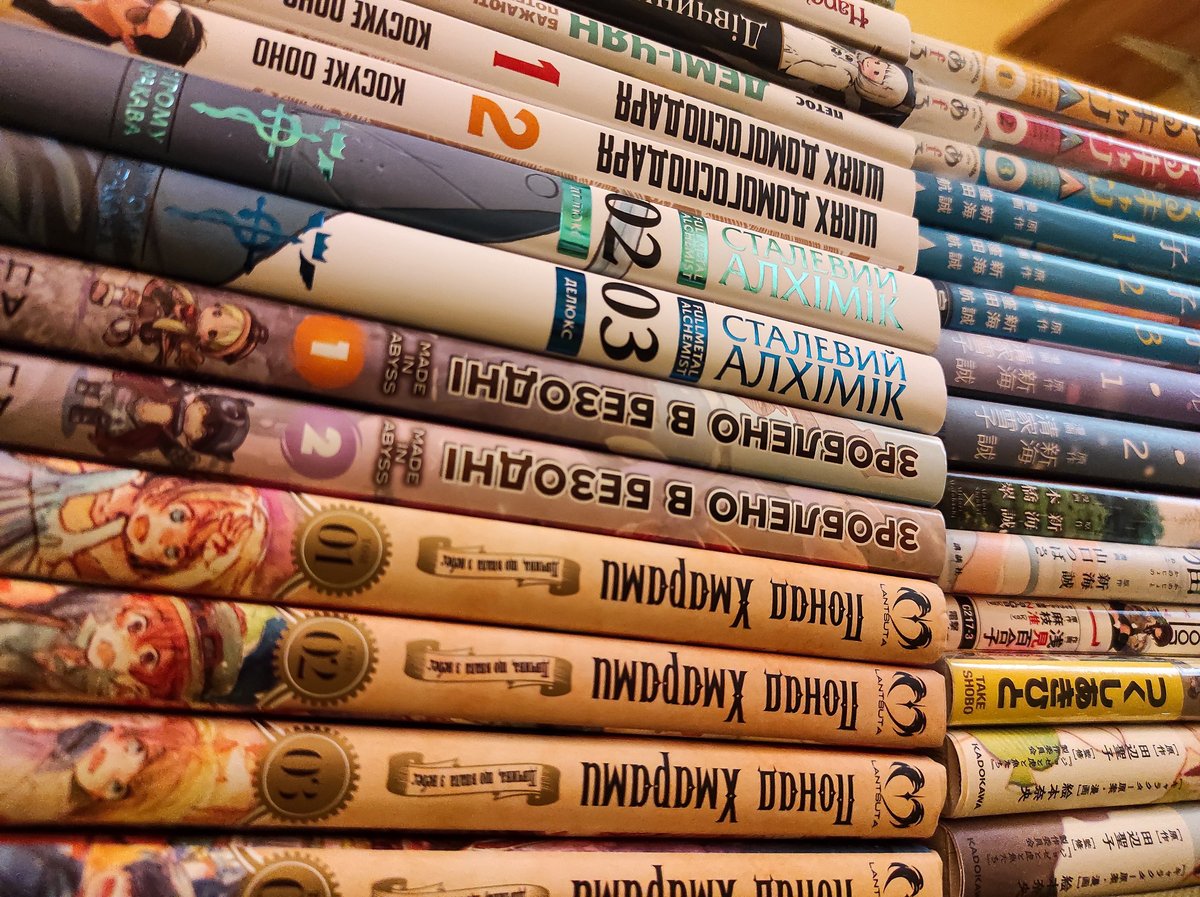 A stack of graphic novels laid out on a table