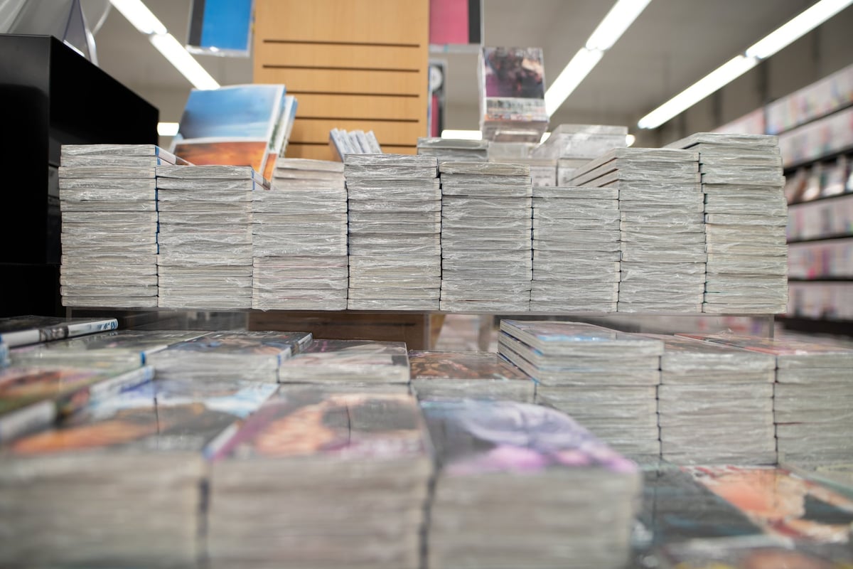 Stacks of comics piled in a bookshop